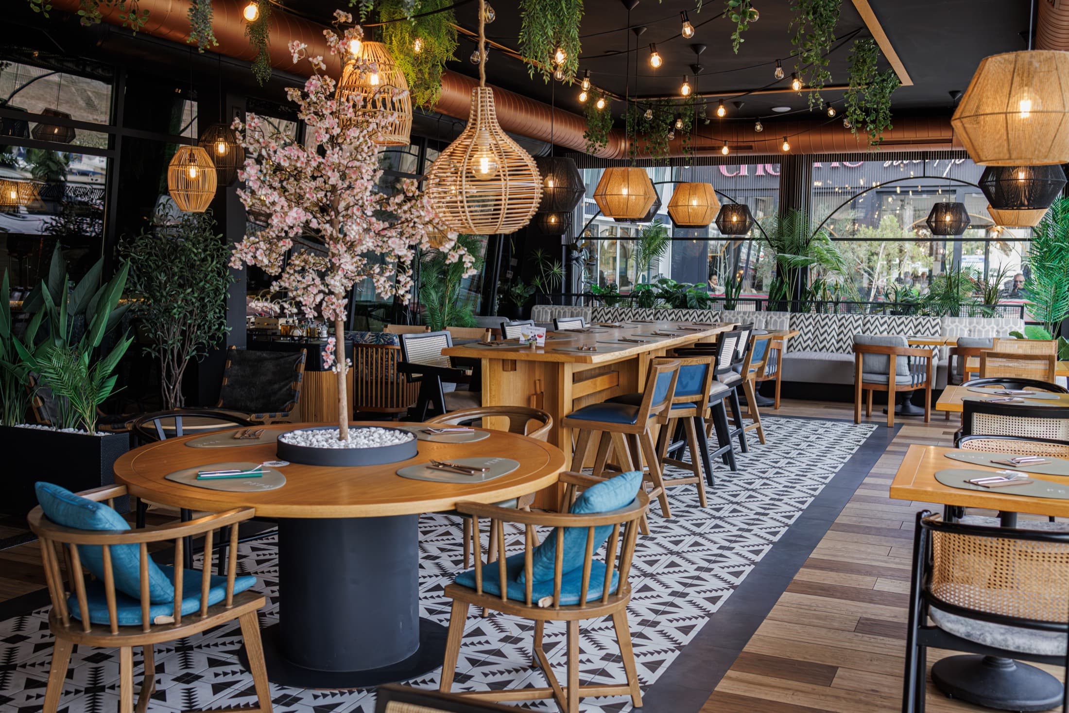 Warm, plant-filled interior of Pépé restaurant